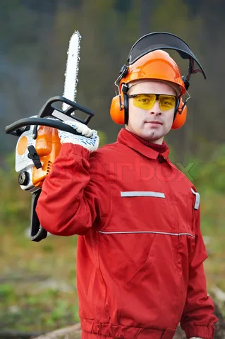 Drwal w kasku ochronnym z pilarką łańcuchową